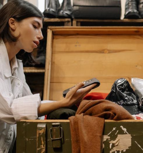 Consignment Boutiques - Woman Looking at the Coin Purse from the Wooden Box