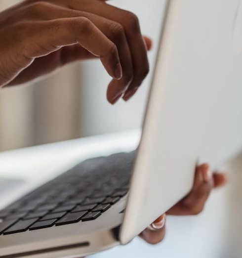 Routers - Close up of Womans Hands Holding Laptop and Pointing at the Screen