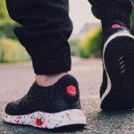 Footwear - Person in Black Sneakers Walking on Street