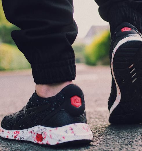 Footwear - Person in Black Sneakers Walking on Street