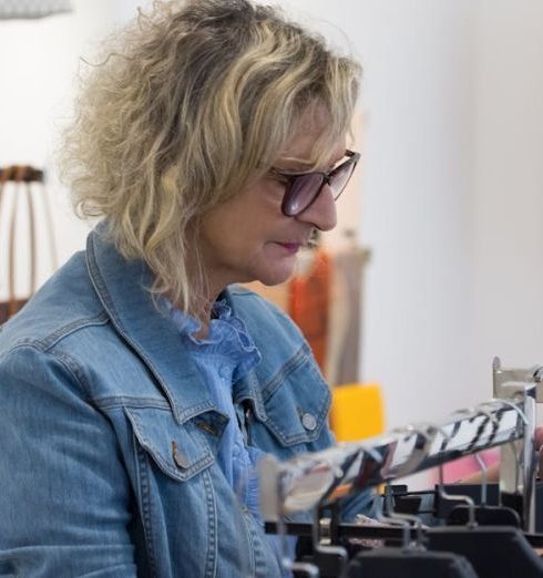 Luxury Brands - An Elderly Woman Choosing Clothes in a Store