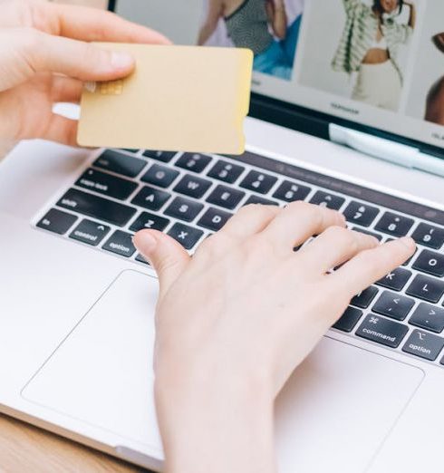 Online Stores - Person using a Laptop While Holding a Credit Card