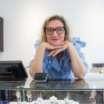 Luxury Watches - Woman in Blue Shirt Standing Behind the Counter