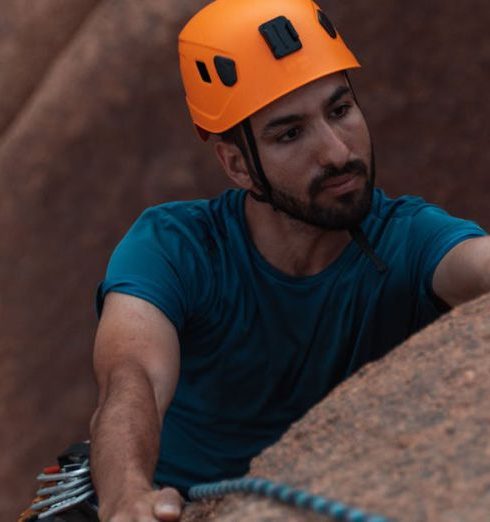 Climbing Equipment - Man in Helmet Rock Climbing