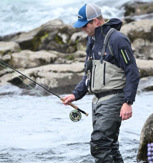 Fishing Gear - Angler Wading with Rod in River