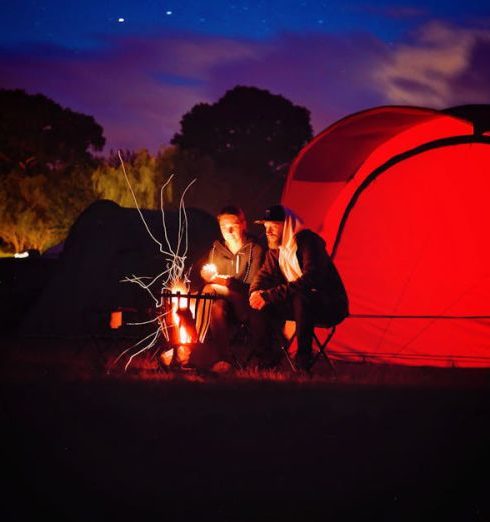 Camping - Man and Woman Sitting Beside Bonfire during Nigh Time