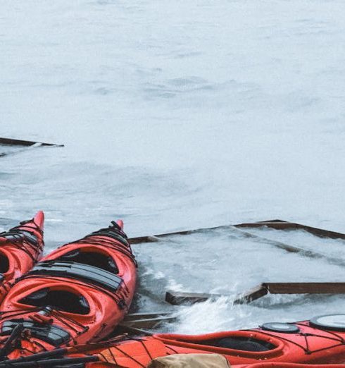 Canoeing Gear - Red Kayaks on a Beach