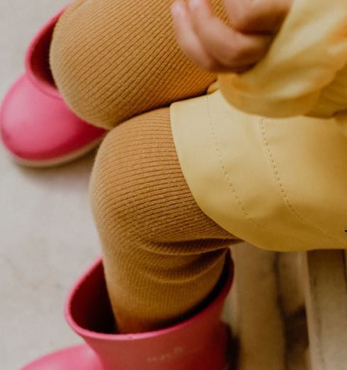 Waterproof Clothing - Little Girl in Pink Wellies and Yellow Raincoat