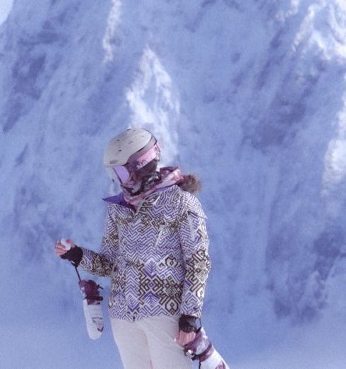 Snowboarding Gear - Person in Jacket and Helmet Standing on Snow