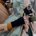 Survival Gear - Man and Woman Wearing Gas Masks