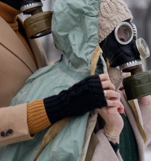 Survival Gear - Man and Woman Wearing Gas Masks