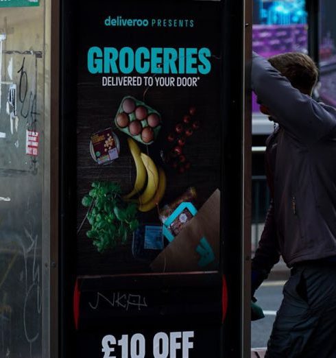 Group Discounts - Person in the Street Standing Beside the Telephone Booth