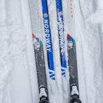 Cross-Country Ski Gear - A Person Wearing Snow Skis on Snow Covered Ground