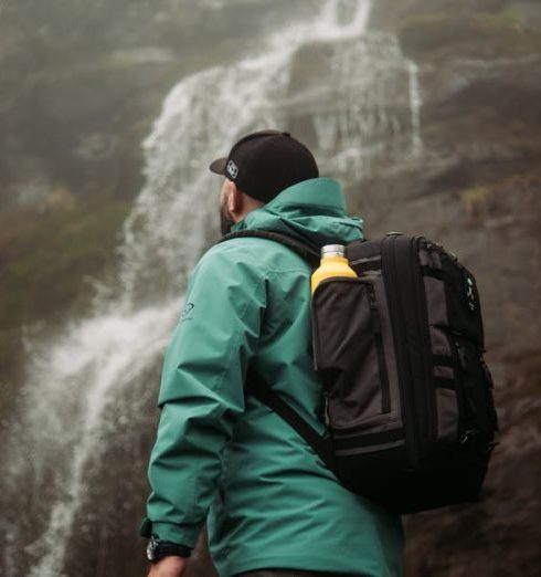 Outdoor Gear - Hiker by the Waterfall