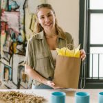 Gift Shops - A Woman Holding a Brown Paper Bag