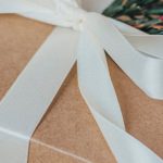 Eco-Friendly Gifts - Close-up of a Christmas Gift with a White Ribbon