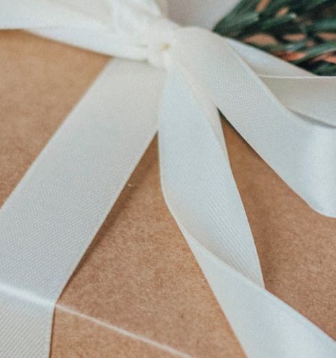 Eco-Friendly Gifts - Close-up of a Christmas Gift with a White Ribbon