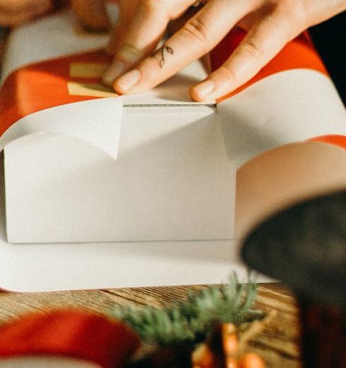 Gift Wrapping - Person Wrapping White Box