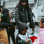 Outdoor Gifts - Volunteer Giving Presents to Children on a Christmas Event in City