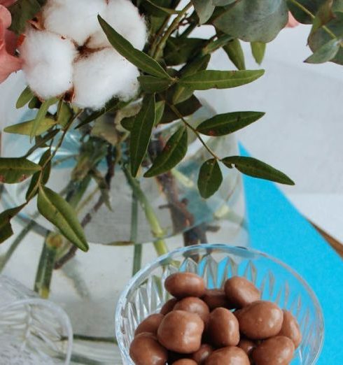 Holiday Gifts - Bouquet in Vase by Bowl of Chocolates