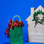 Housewarming Gifts - Gift Bag Beside a Mother's Day Wooden House Shape Ornate with Qoutes