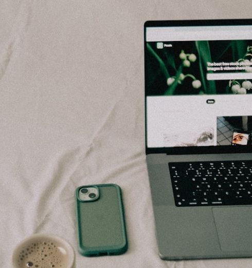 Tech Gadgets - A Coffee and Electronics Standing on the Bed