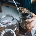 Home Goods - A Person Refilling Beans on a Glass Jar