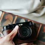 Bespoke Fashion - Man Holding Newspaper and Retro Camera