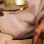 Rare Books - A Person Holding a Magnifying Glass and a Paper