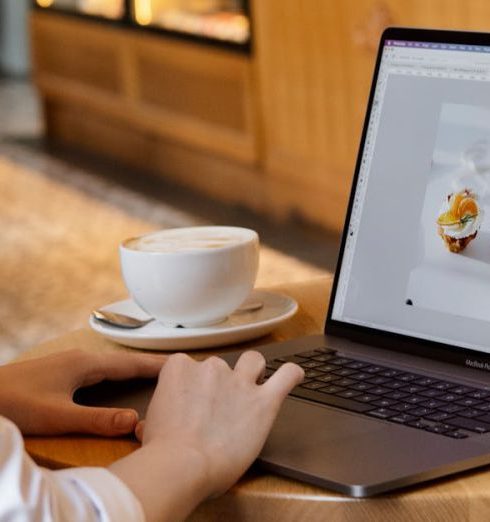 Online Bookstores - Woman Using a Laptop at the Coffee Shop