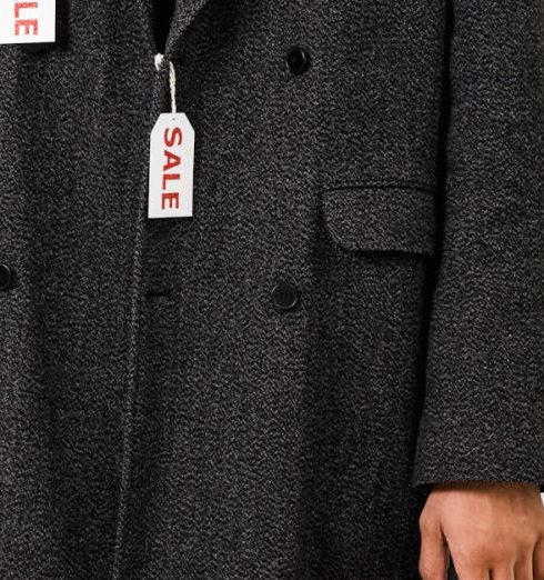 Discounts - Man Wearing Gray Coat With Sale Tags