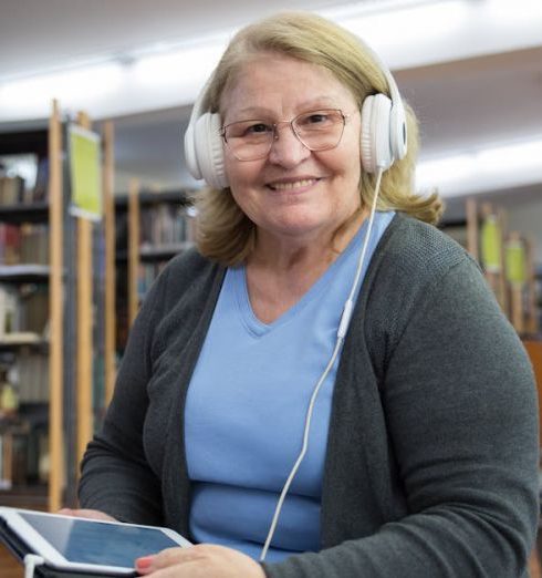 Audiobooks - Woman in Gray Cardigan Holding White Ipad