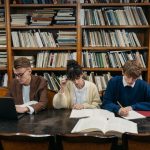 Reference Books - College Students Studying in a Library