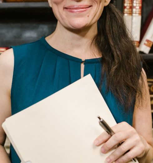 Knowledgeable Staff - A Woman in Blue Sleeveless Shirt Smiling at the Camera