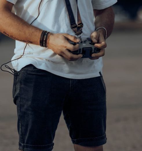 Wearable Tech - Man Wearing Goggles and Holding a Controller for a Drone