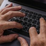 Home Office Gadgets - Elderly Person Typing on Keyboard