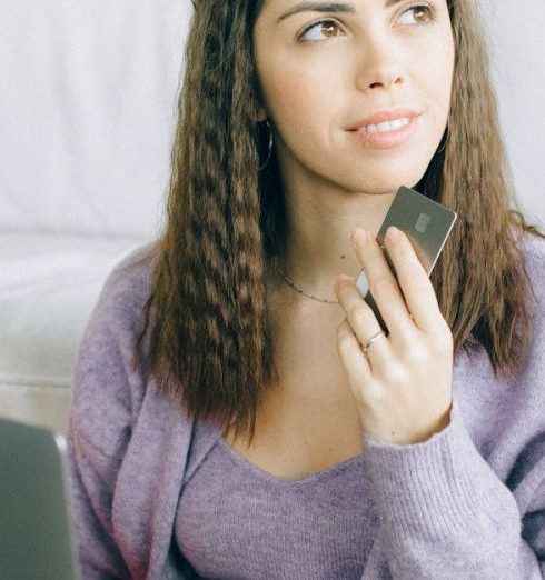 Affordable Gadgets - Woman Holding a Credit Card and a Laptop