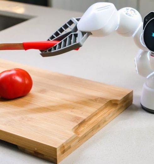 Smart Kitchen Gadgets - A Clicbot About to Cut a Tomato Using a Knife