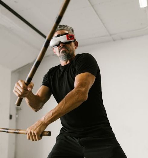 Fitness Gadgets - Man using an Arnis while wearing Virtual Reality Glasses