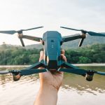 Photography Gadgets - Man Holding Drone over River