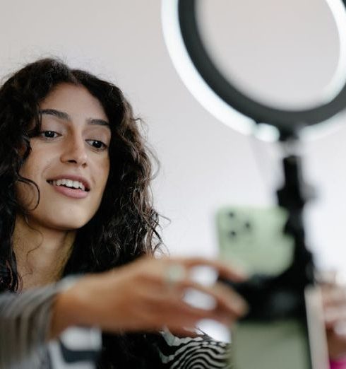 Streaming Gadgets - Woman Using Smartphone for Recording