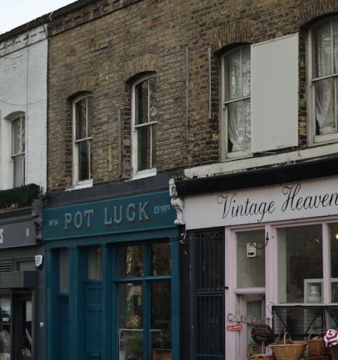 Vintage Shops - Townhouse with Shops, and Bicycles Parked on a Pavement