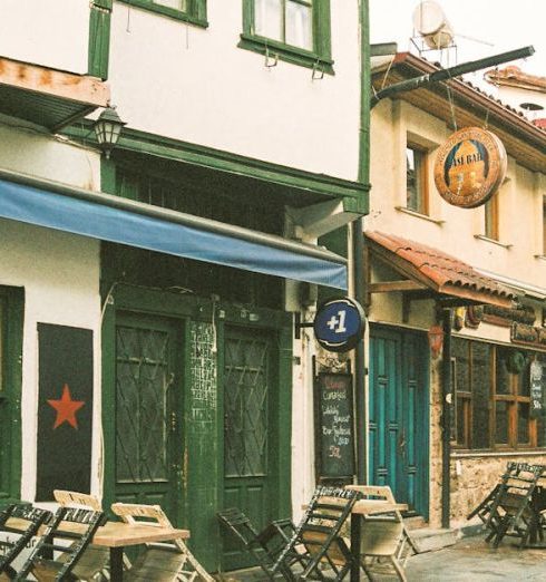 Antique Stores - Brown Wooden Chairs and Tables Outside Restaurants