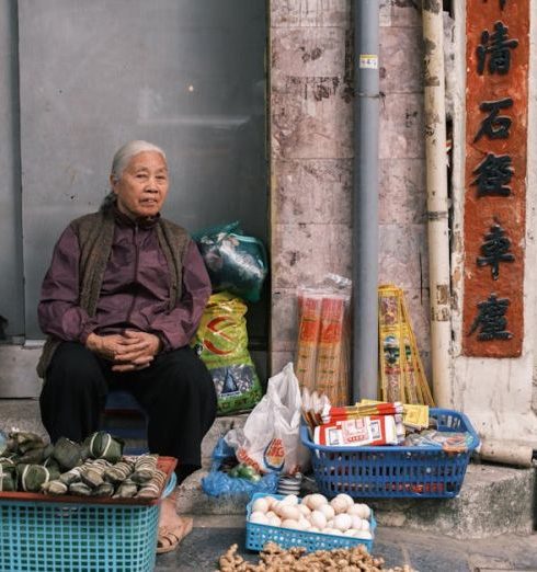 Vintage Markets - Woman Sitting and Selling Food on a Street Corner