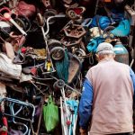 Vintage Items - Men Standing in Front of a Storage Full of Trash