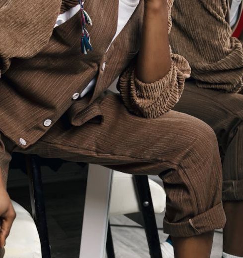 Vintage Fashion - Woman Wearing brown outfit next to a mirror