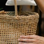 Home Goods - Person Putting Pouch on Woven Basket