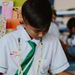 Children’s Books - Thai Boy Sitting Cross-legged on Ground Reading Book