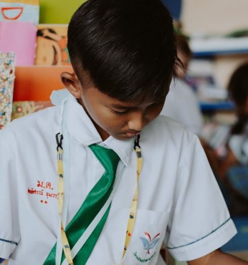 Children’s Books - Thai Boy Sitting Cross-legged on Ground Reading Book