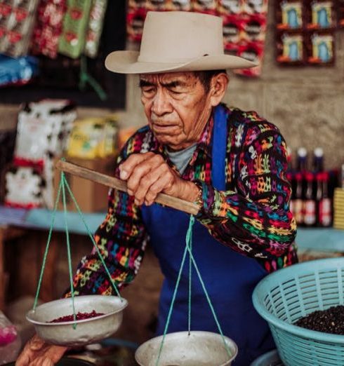 Shopping Experiences - Merchant Working at Market Stall